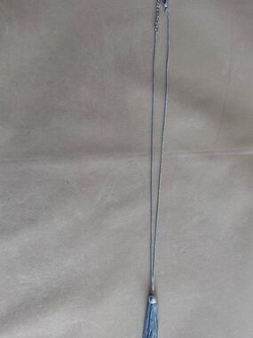 Silver-tone chain necklace with a tassel pendant